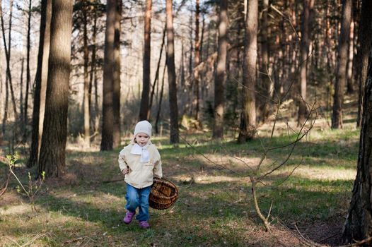An image of a little child in the spring forest