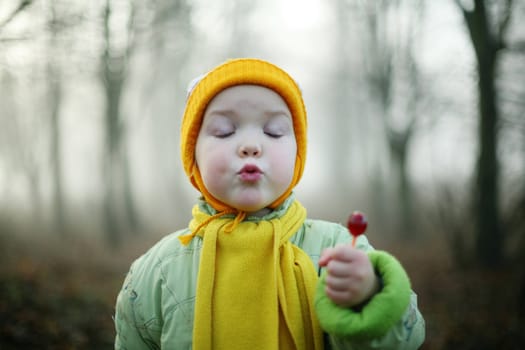 An image of a nice girl with a candy