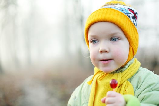 An image of a little girl with a candy