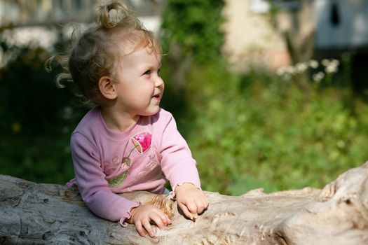 An image of  baby girl playing outdoor