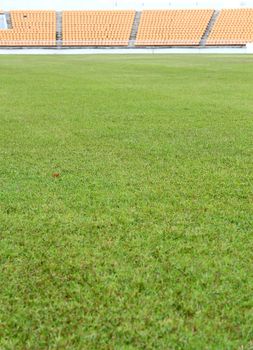 bleachers with green field background