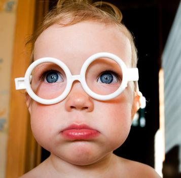 An image of a nice baby-girl in toy-glasses