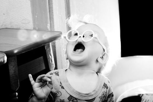 An image of a baby in toy-glasses