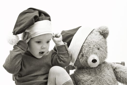 An image of nice baby in red hat with toy