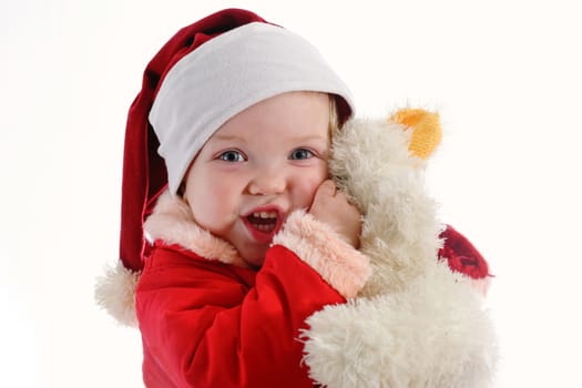 Christmas baby in Santa hat with toy bear