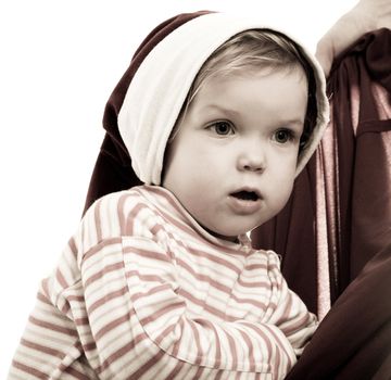 Baby in hat looking into cristmas bag