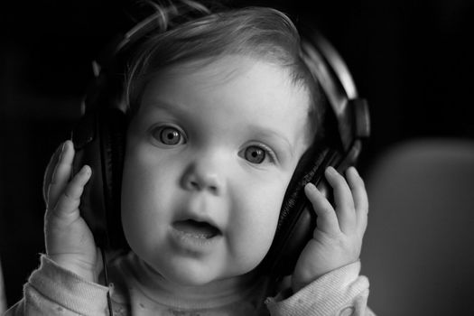 An image of baby listening to music