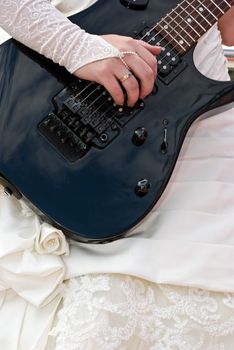 The Close up of a female hand with a guitar