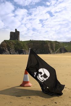 sandy golden beach with jolly roger flag in ballybunion county Kerry Ireland with castle in background