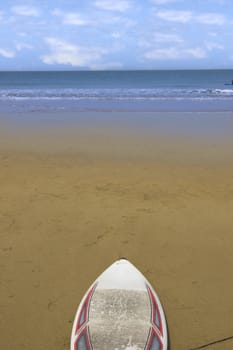 sandy golden beach with surfboard lying on the sand in ballybunion county Kerry Ireland