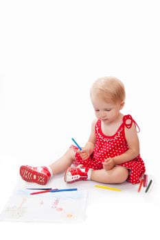 Little baby girl drawing at her album over white