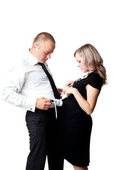 A pregnant woman and her husband with little shoes