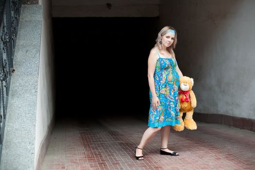 An image of a pregnant woman with a teddy-bear