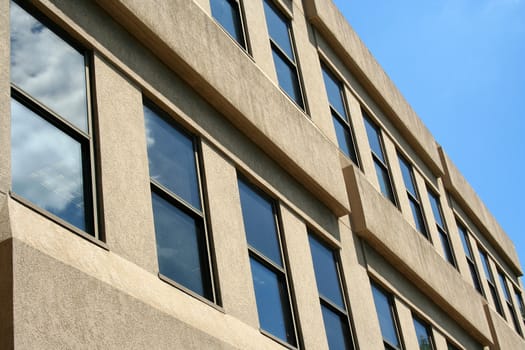 Office building windows with blue sky