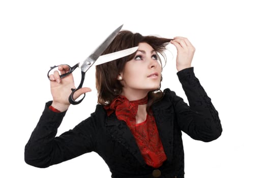 A woman with big scissors going to cut her forelock