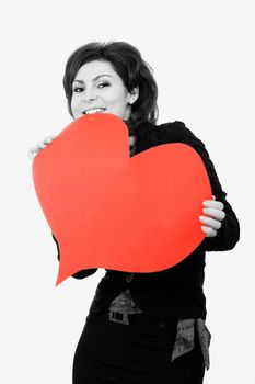 A girl keeps a big red paper heart