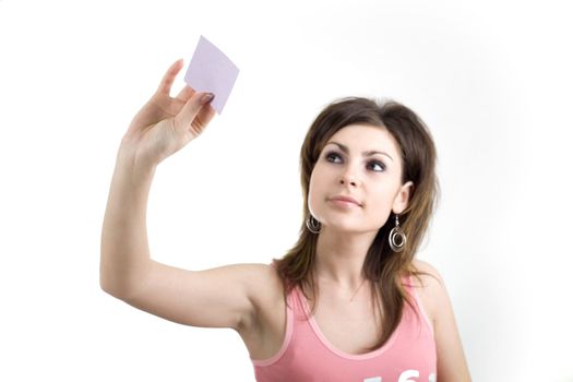 A girl sticking a note on the glass wall