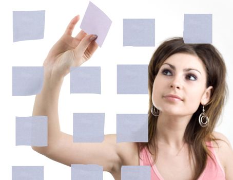 A girl sticking notes on the wall