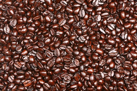 Coffee beans texture background. Coffee bean heap close up of dark roasted arabica bean.