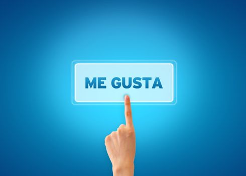 Hand pointing at a Me Gusta icon on blue grandient background. 