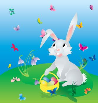 easter hare on the green grass under blue sky with eggs in basket and butterflies around
