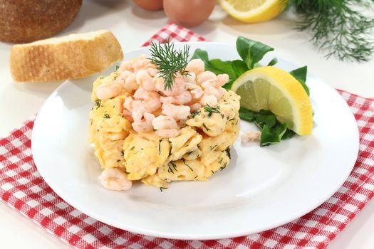 Scrambled eggs with shrimp, dill and corn salad on a plate