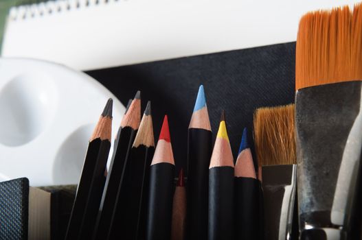 Close up of a selection of artist's tools and materials.  Horizontal (landscape) orientation.