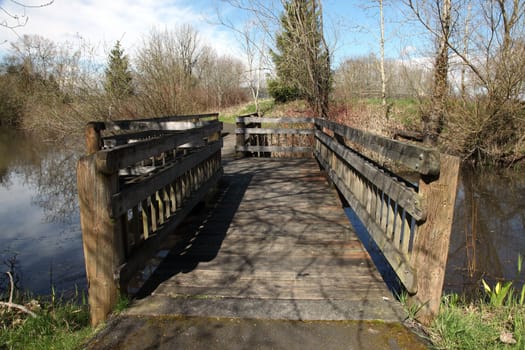 A bridge leading around a small creek in a park, Oregon.