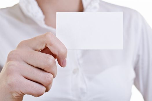 Businesswoman showing and handing a blank business card. Business woman in white shirt, high key. 