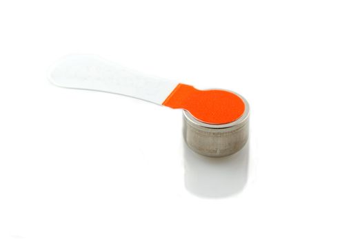 Small digital hearing aid battery on white