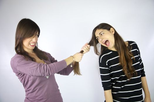 girl pulling the long hair of her friend