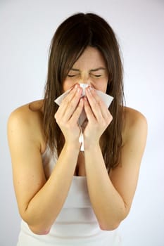 Very sick girl sneezing hard