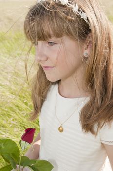 girl wearing first communion dress in the meadow