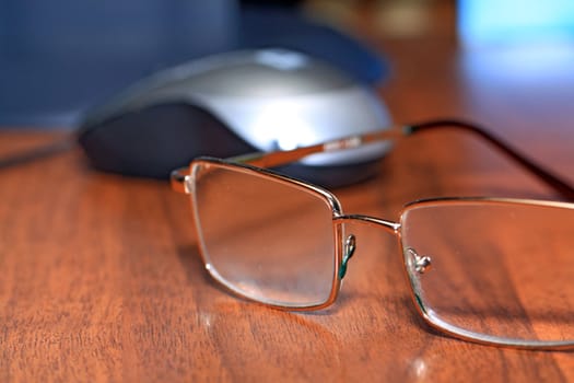 spectacles on wooden table