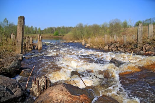 river flow on old destroyed dam