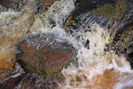 quick river flow amongst stone