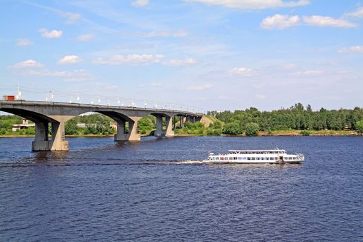 small promenade motor ship on big river near bridge
