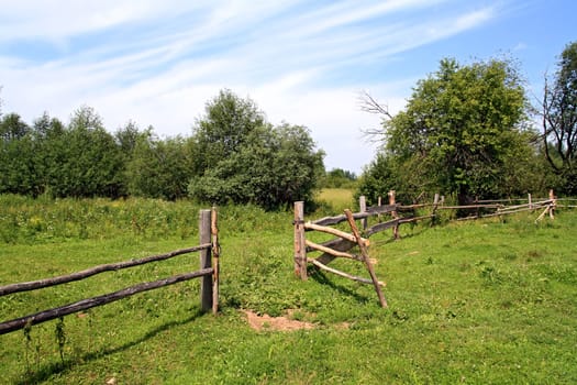 wooden fence on green pasture
