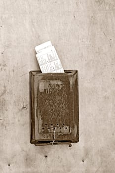 old mailbox on wooden door, sepia