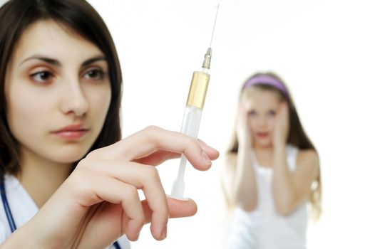 Doctor getting ready to make an injection to a young girl