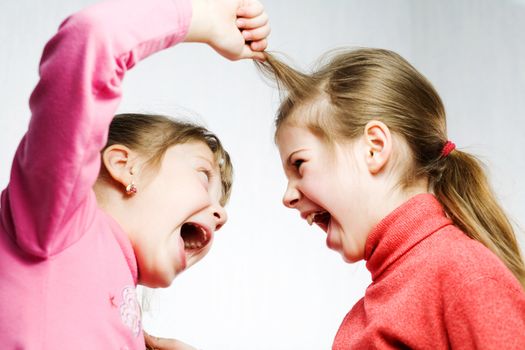 Stock photo: an image of two girls fighting and shouting