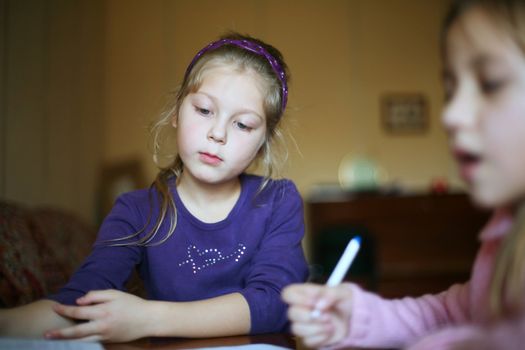 An image of two little girls doing homework