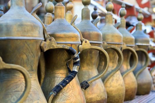 Arabic tea pots made of brass lined up