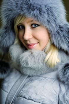 An image of a nice woman in grey fur hat