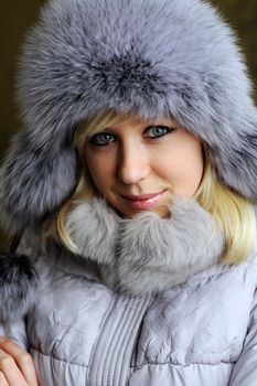 An image of a nice woman in grey fur hat