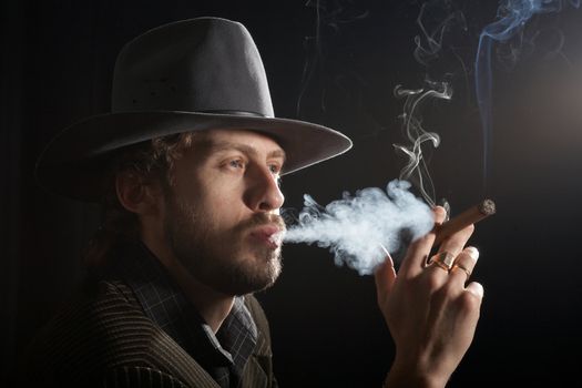 An image of a bearded man in felt hat