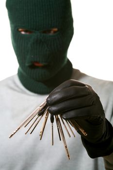 An image of a man in dark mask with a bunch of keys