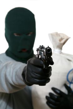 An image of a man in mask with gun and bag