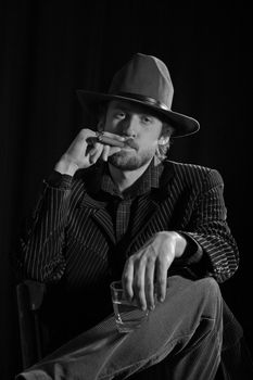 An image of a bearded man smoking cigar