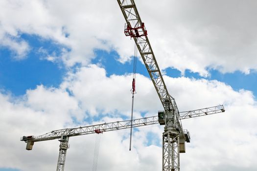 Hoisting crane on blue sky